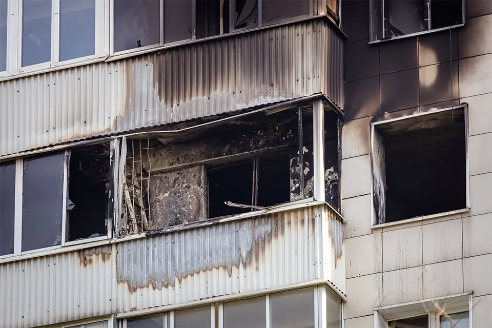 Burned building exterior with broken windows