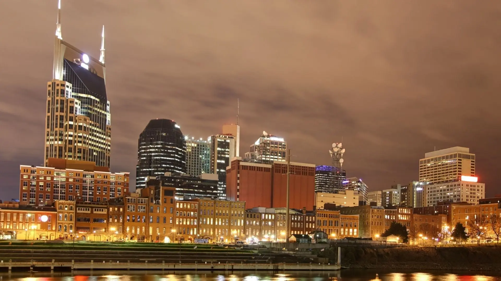 City skyline at night with lights reflecting