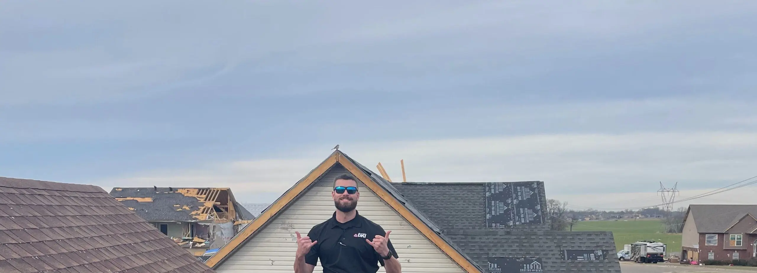 Man posing on rooftop with sunglasses