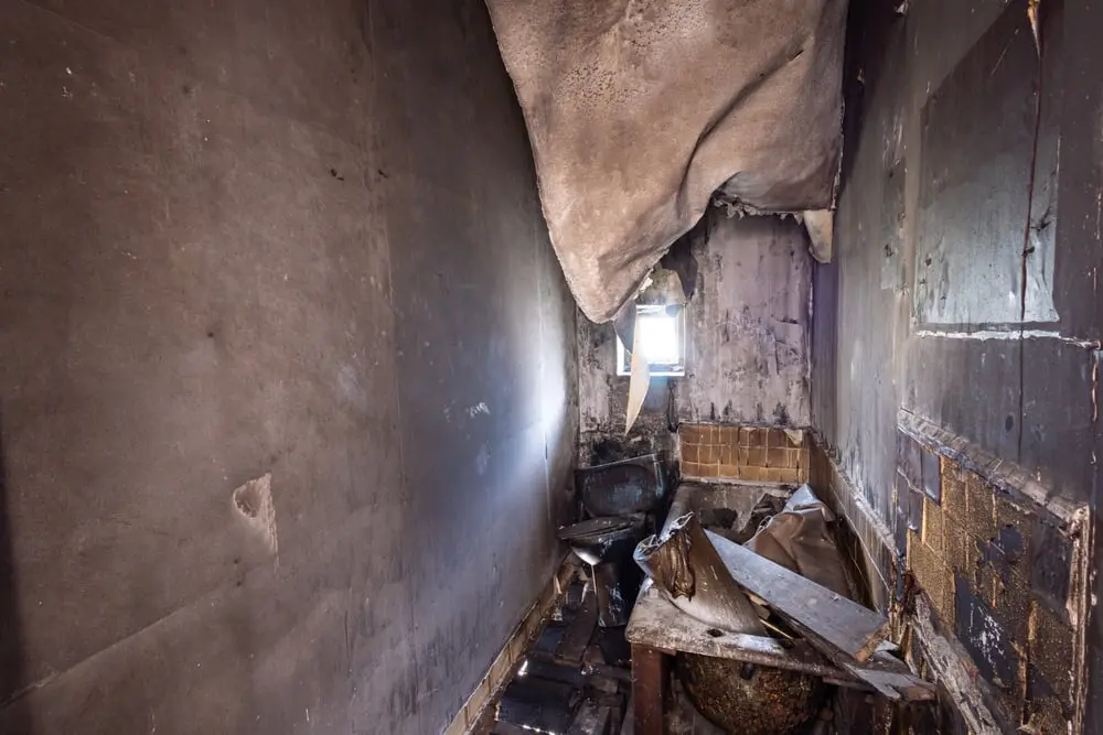 Fire-damaged interior with smoke-stained ceiling.