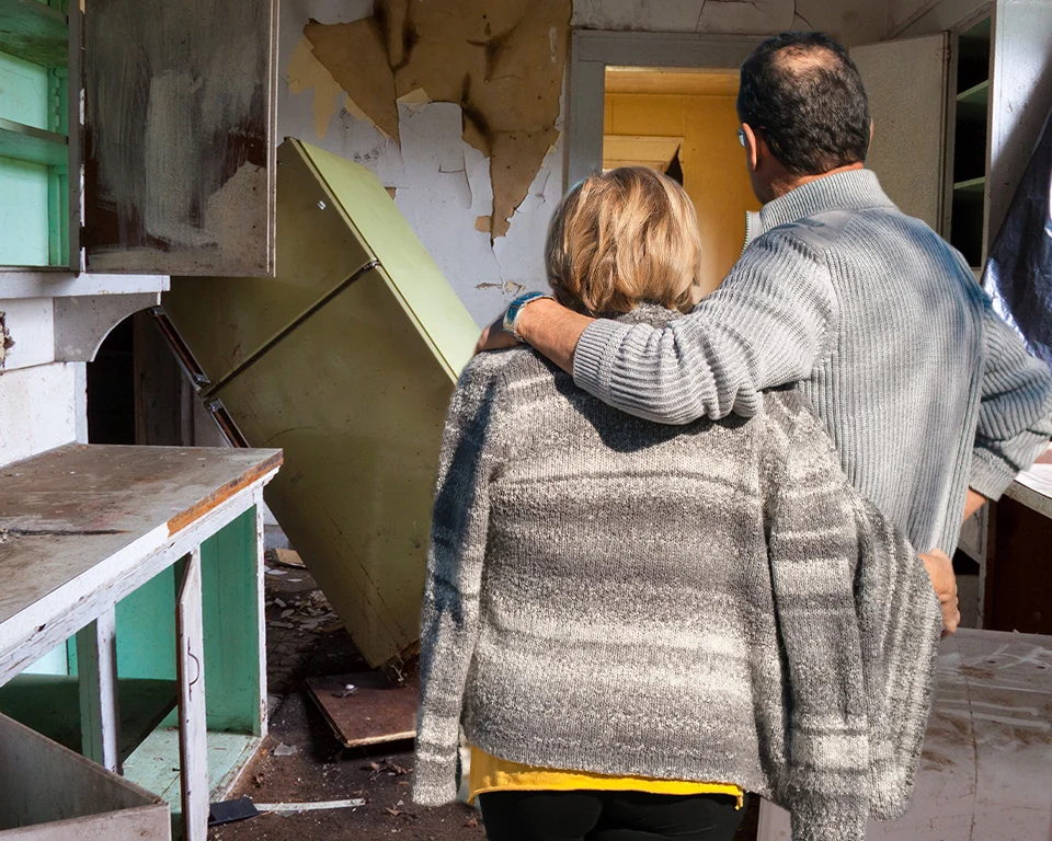 Two people in abandoned kitchen