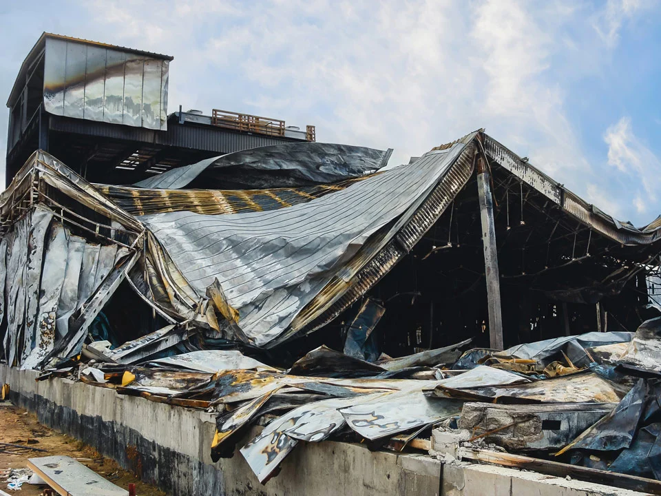 Ruined structure with twisted metal roof